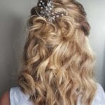 Wavy blonde hair styled with decorative hairpins.