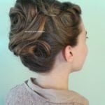 A woman with an elegant updo hairstyle viewed from the side.