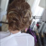 Elegant updo hairstyle on a woman with brown hair.