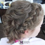 A close-up of a braided hairstyle on light brown hair.