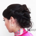 Side profile of a woman with an elegant updo hairstyle.