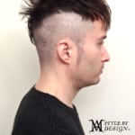 Side profile of a man with a unique undercut hairstyle.