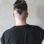 Rear view of a person with a unique undercut hairstyle.