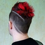Rear view of a person with a red mohawk and shaved design.