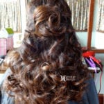 Back view of long, curly brown hair styled elegantly.