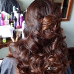 Elegant hairstyle with loose curls and a twisted bun.