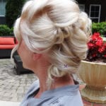 Elegant updo hairstyle with soft curls and volume.