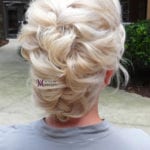 Intricately braided blonde hair styled into an elegant updo.