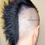 Side view of a person with a mohawk haircut and shaved sides.