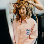 A woman getting her hair styled at a salon.