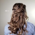 Back view of long wavy hair styled with braids.