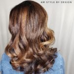 Stylish medium-length wavy hair with subtle highlights.