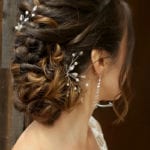 Elegant bridal hairstyle with intricate braids and pearl accents.