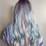 Back view of long hair dyed in pastel blue and purple shades.