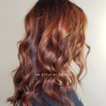 Wavy auburn hair styled elegantly on a person.