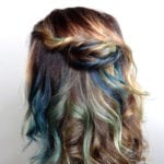 Back view of wavy hair with brown and blue highlights.