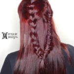 Intricate braided hairstyle on long, red hair.