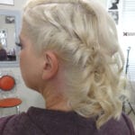 Side view of a woman with a braided blonde hairstyle.