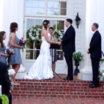 Wedding ceremony with bride and groom exchanging vows outdoors.