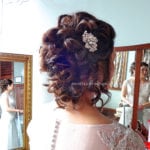 Intricate bridal hairstyle with floral hair accessory.