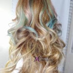 Curly blonde hair with blue highlights.