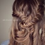 Intricate fishtail braid hairstyle on light brown hair.