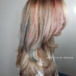 Pastel rainbow highlights on blonde hair.