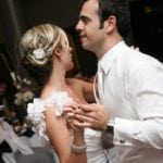 A couple dancing closely at a wedding reception.