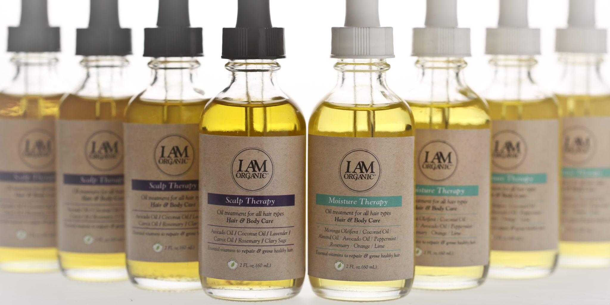 Four bottles of L&M natural oil blends for hair and skin care.