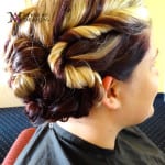 Intricate hairstyle with twisted braids and soft curls.