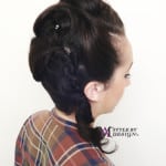 Side view of a woman with a braided hairstyle.