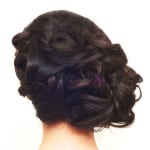 Elegant braided updo hairstyle on dark hair.
