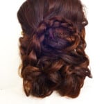 Intricately braided and curled brunette hair styled elegantly.