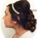 Profile of a woman with an elegant updo and pearl accessories.