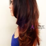 Profile of a woman with long, layered brown hair.