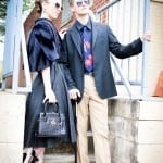 Two stylish individuals posing outdoors in fashionable attire.