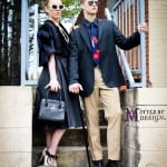 A stylish couple walking outdoors in fashionable attire.