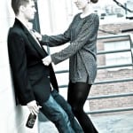 A couple sharing a moment outdoors, the man holding a bottle.