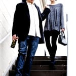 A man and woman descending stairs, dressed casually.