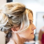 Profile of a woman with blonde hair styled in an elegant updo.