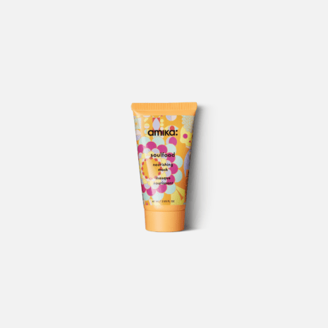 A small yellow tube of skincare product on a plain background.