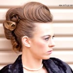 Woman with an elegant vintage hairstyle and pearl necklace.