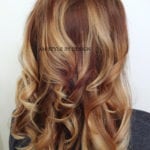 Long, wavy hair with golden highlights.