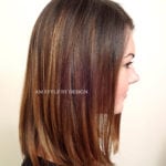 Side profile of a woman with straight, shoulder-length brown hair.