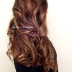 Long wavy brown hair with subtle highlights.