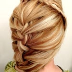 A close-up of a blonde hair styled in a loose braid.