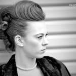 Black and white portrait of a woman with vintage hairstyle.