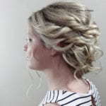 Elegant blonde hairstyle with intricate curls and braids.