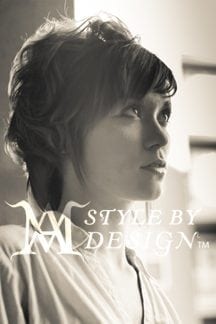 Portrait of a woman gazing thoughtfully in soft sepia lighting.