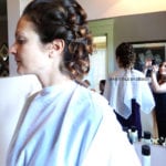 Woman with a braided updo hairstyle in a salon.